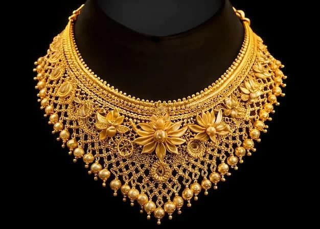 Ornate gold temple-style necklace with pearl and floral detailing